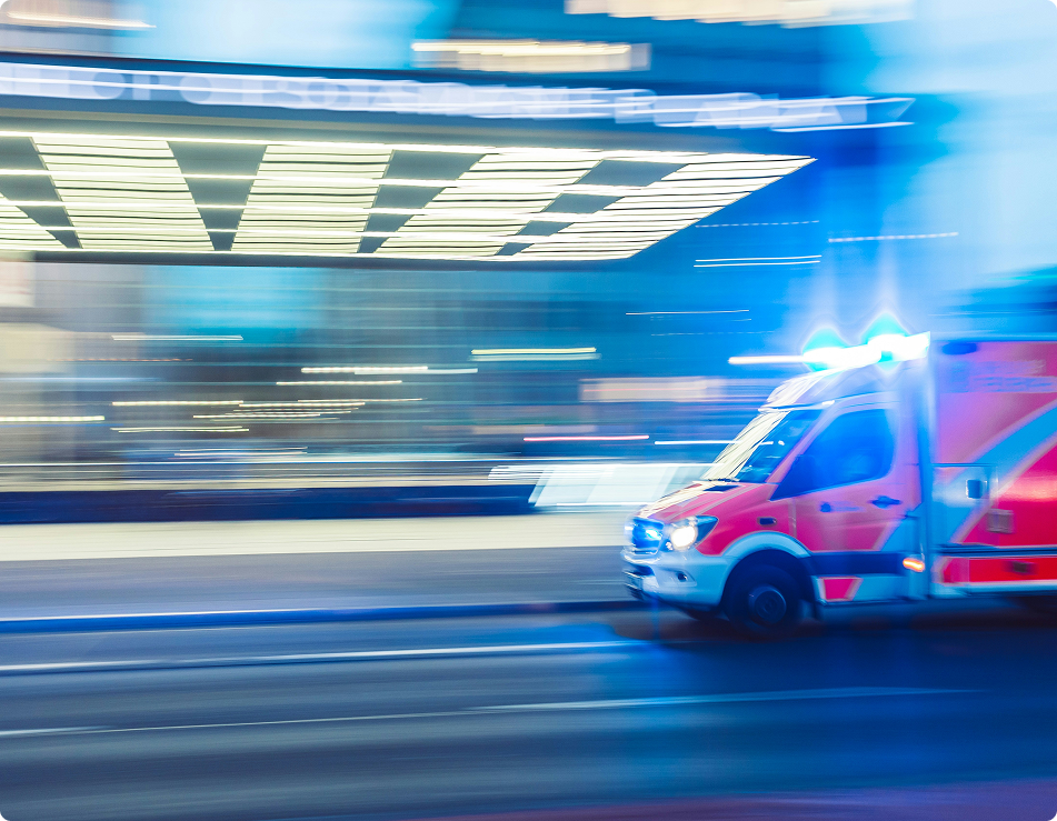 ambulance driving down the road, blurred image showing motion