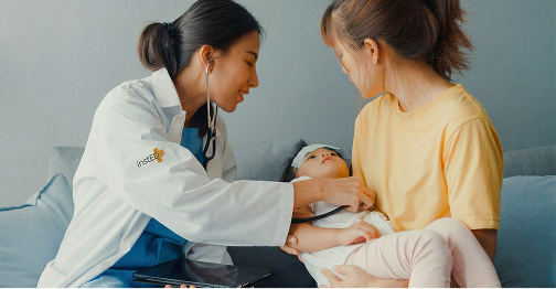 insted worker at a patients home examining a child in the mothers arms
