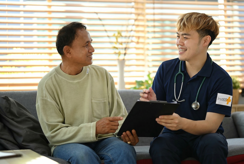 insted worker completing paper work with a patient